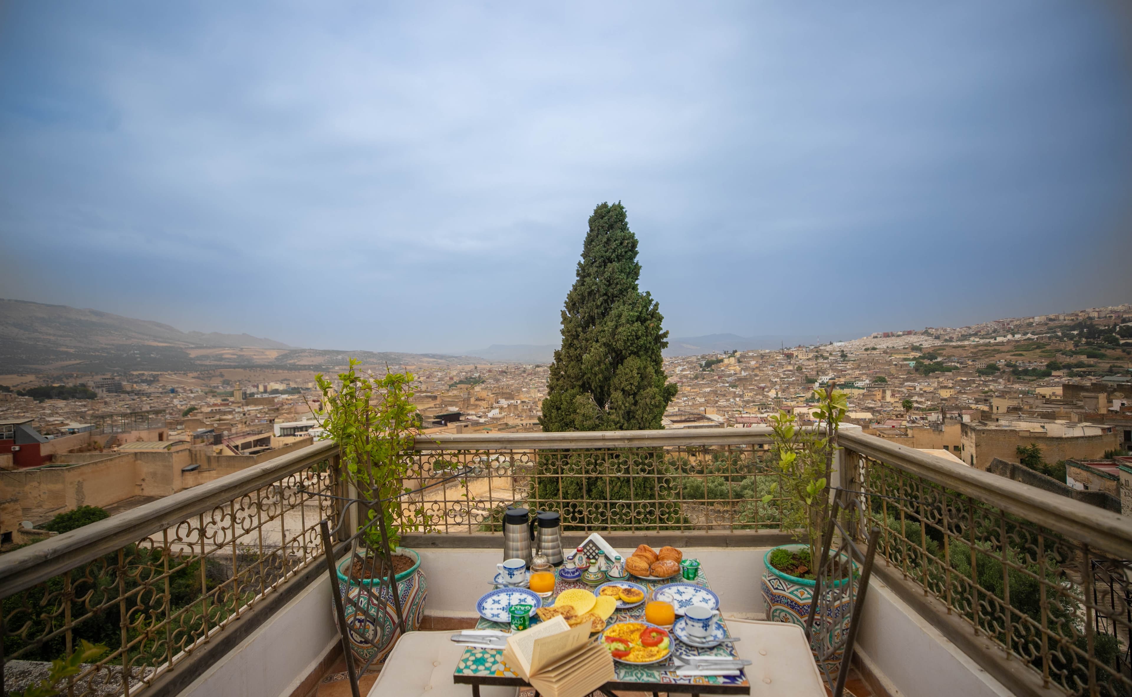 Moroccan breakfast on the rooftop terrace with panoramic view over Fez medina