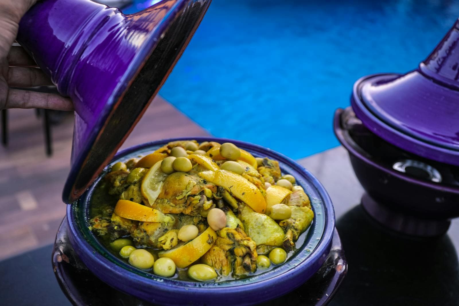 Moroccan tagine with preserved lemon and olives being served
